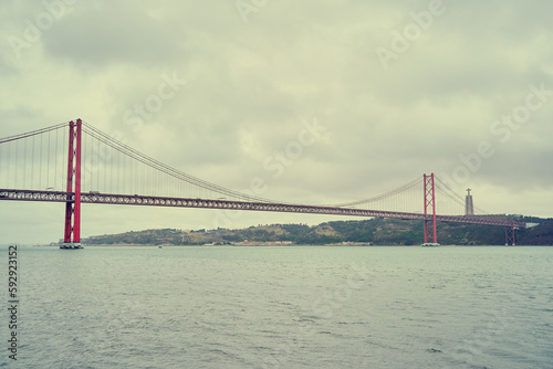 Beautiful landscape with suspension 25 April bridge bridge over the Tagus river in Lisbon, Portugal.