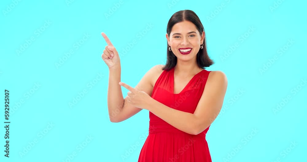 Smile, face and woman on blue background pointing to mockup, studio and color backdrop. Portrait of happy female model advertising promotion, discount sales or brand presentation of offer coming soon Smile, face and woman on blue background pointing to mockup, studio and color backdrop. Portrait of happy female model advertising promotion, discount sales or brand presentation of offer coming soon