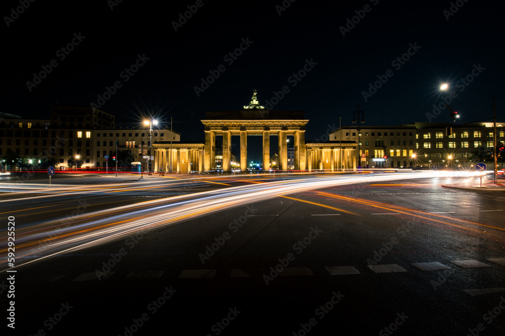 Fototapeta premium Long exposure of car headlights and the beauty of Brandenburg Gate in Berlin at night