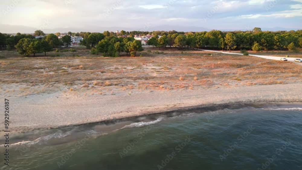 Gorgeous drone-shot view of peaceful tides washing ashore on a beach in Keramoti, Greece Gorgeous drone-shot view of peaceful tides washing ashore on a beach in Keramoti, Greece