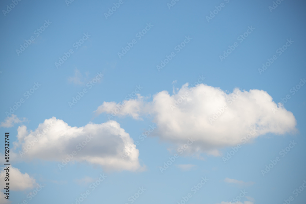 Blue sky with white fluffy clouds in sunny weather. Blue sky with white fluffy clouds in sunny weather.