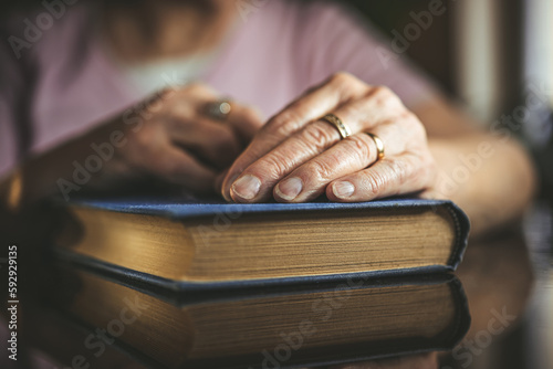 Elderly woman holding a book. 