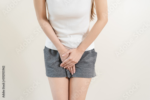 Canvas Print woman having painful lower stomach and hands holding pressing her crotch lower a