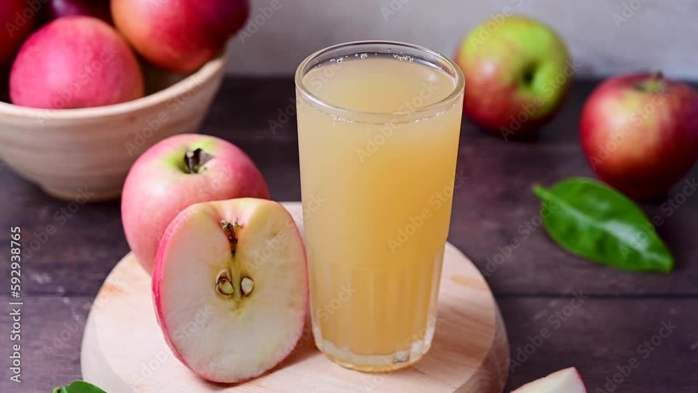 Apple juice in drinking glass, with fresh mint and red apples. Apple juice in drinking glass, with fresh mint and red apples.