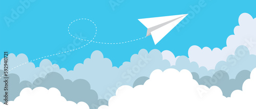 Simple clip art of a paper plane in flight over clouds