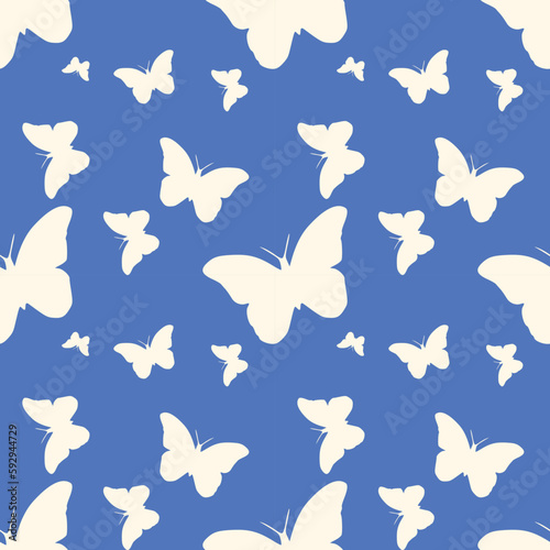Beautiful seamless vector wallpaper with lovely white butterflies on a soft blue background