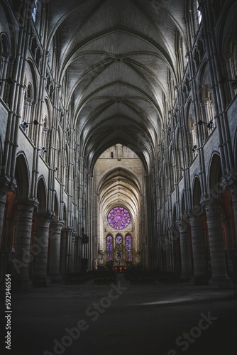 Low angle of indoorws inside of Laon Cathedral  France with long corridor with arch gates