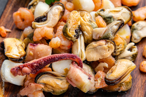 seafood salad shrimp, mussel, scallop, octopus meal food snack on the table copy space food background rustic top view 