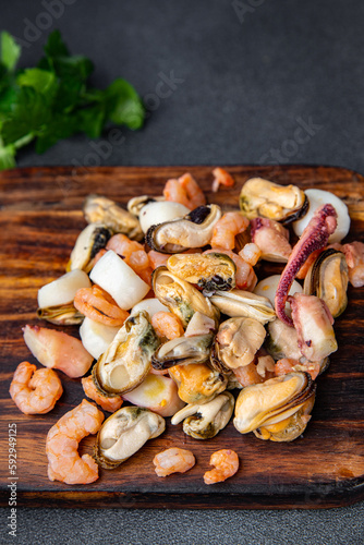 seafood salad shrimp, mussel, scallop, octopus meal food snack on the table copy space food background rustic top view 