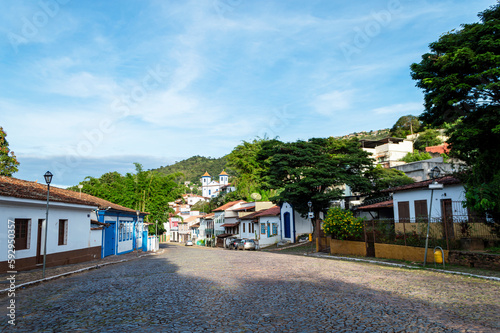 Sabará. Beautiful colorful old mansions in the historic city of Sabará. Brazil. Blue sky. Stone-paved street.