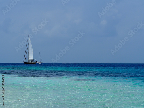 Sailing boat, clear water and beach in the Caribbean