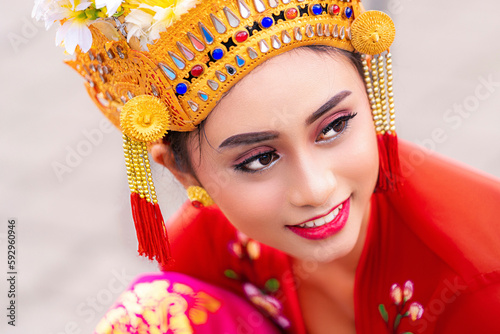 Indonesian girl with traditional costumn dance in bali temple photo