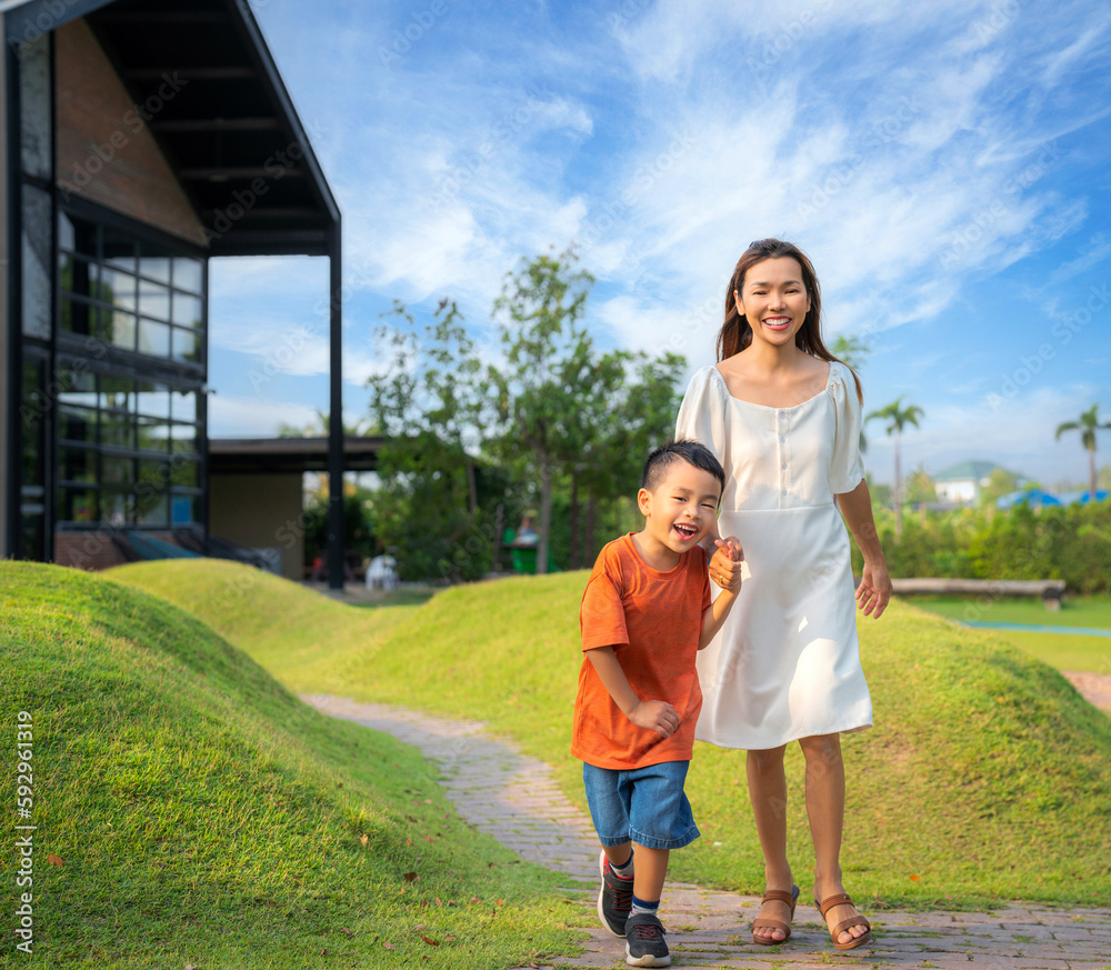 Asian mother and her som running togather on the garden