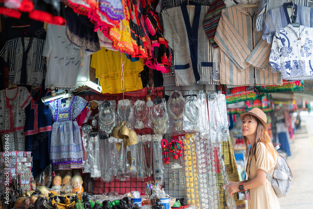 Asian traveller woman shoping traditioanl goods in souvenir shop in walking street in Chiang mai