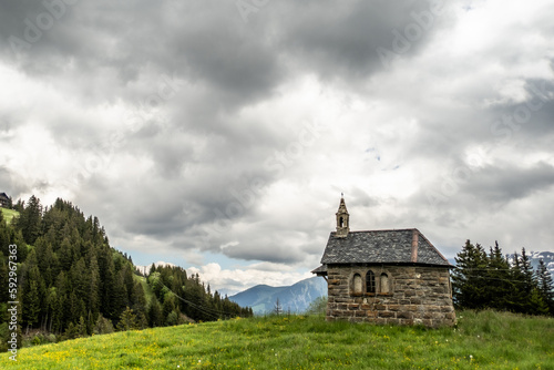 stone church in the mountains against cloudy sky