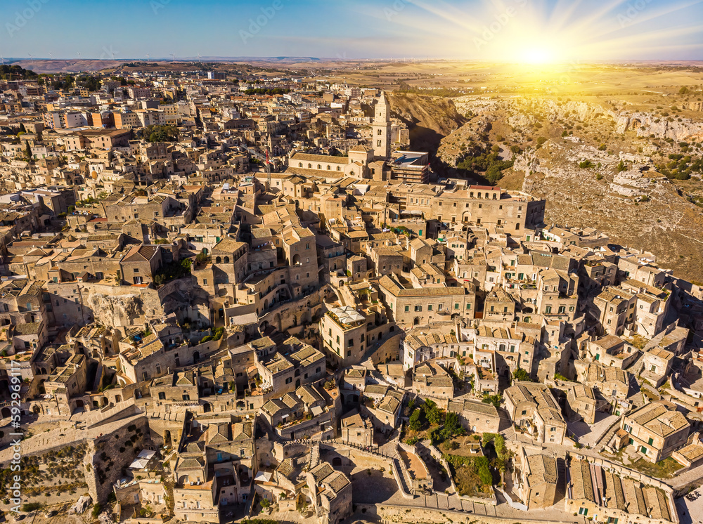 Aerial view of medieval city of Matera Sassi di Matera in beautiful golden morning light at sunrise. Birds view of Sassi di Matera, in Basilicata, southern Italy