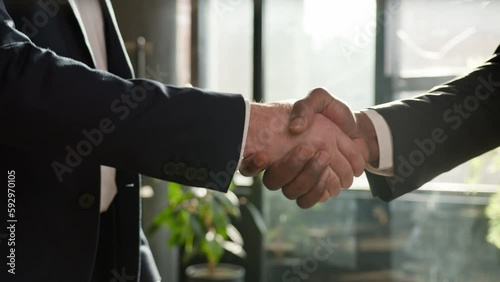Close up two diverse men shake hands multiracial businessmen conclude successful contract agreement multiethnic business partners handshake support partnership cooperation greeting in office male arms