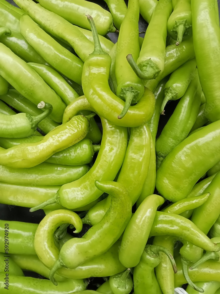 pile of large green chilies that are suitable as an addition to dishes