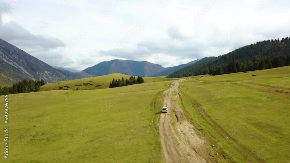 Car driving on the mountain meadow Car driving on the mountain meadow