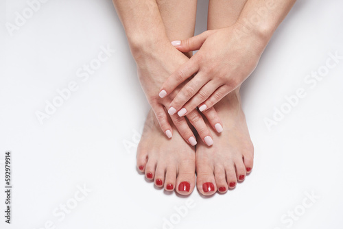 Female hands and feet with manicure and pedicure