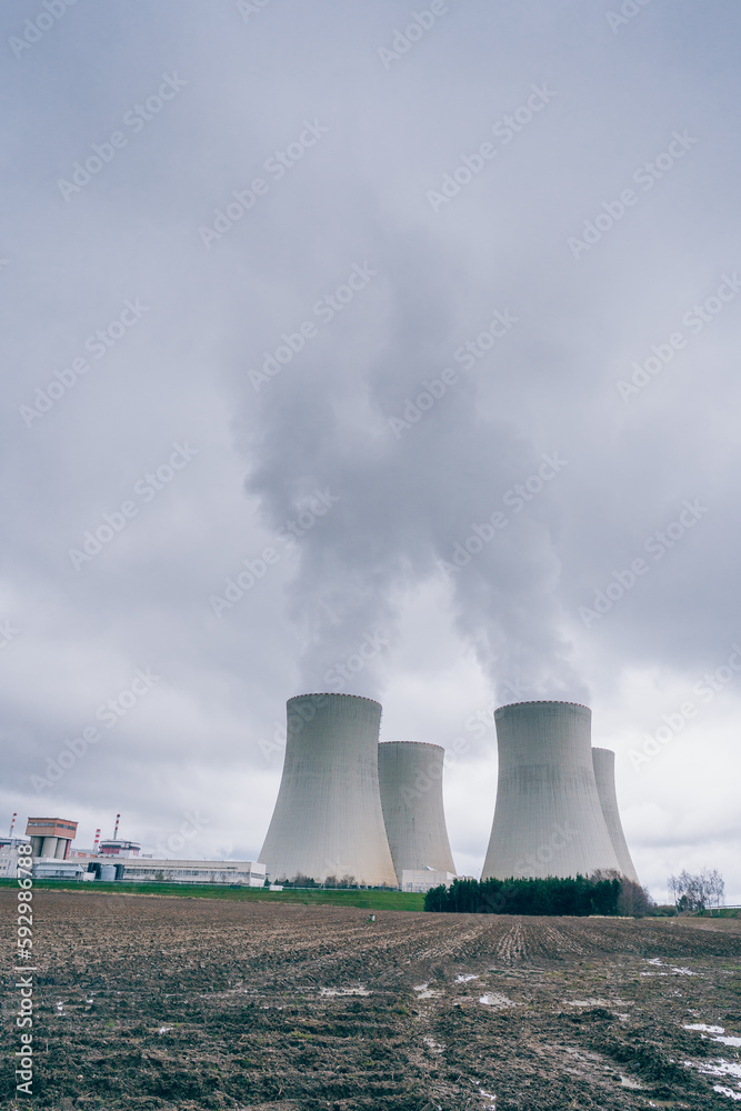 The cooling towers of the Temelín nuclear power plant with a cloudy sky in the background. Nuclear power plant. The cooling towers of the Temelín nuclear power plant with a cloudy sky in the background. Nuclear power plant.