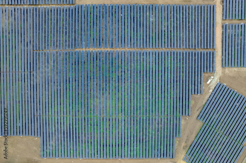 Aerial drone shot. Solar panels farm in a field.
