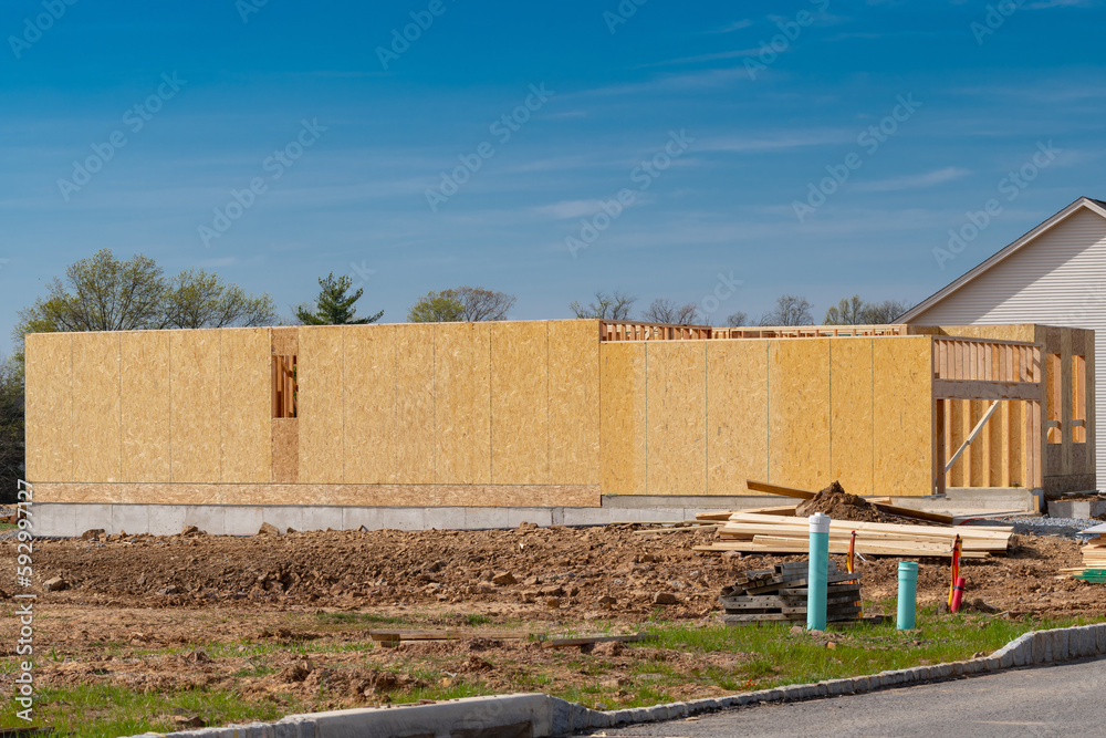 construction of a new plywood house against the blue sky