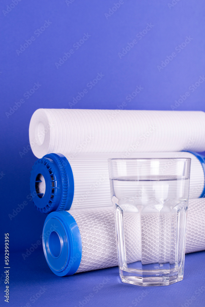 set three of cartridges for water filter with clear glass of water ...