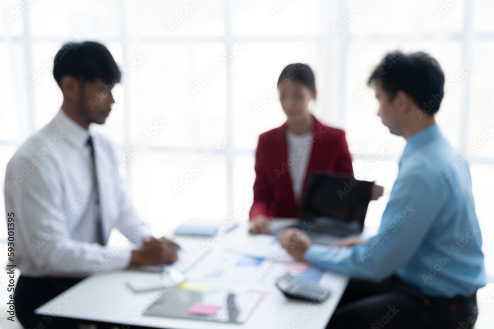 Blurred image of businesspeople working together in the meeting room.