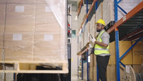 Warehouse worker on a forklift getting the load down