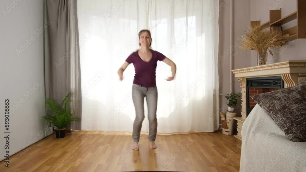Energetic, athletic woman dancing at home. Active and joyful perception of life. Energetic, athletic woman dancing at home. Active and joyful perception of life.