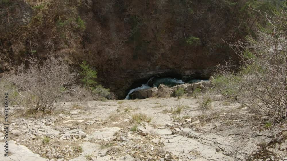 Top view of powerfull river in a canyon from a steep slab with trees Top view of powerfull river in a canyon from a steep slab with trees
