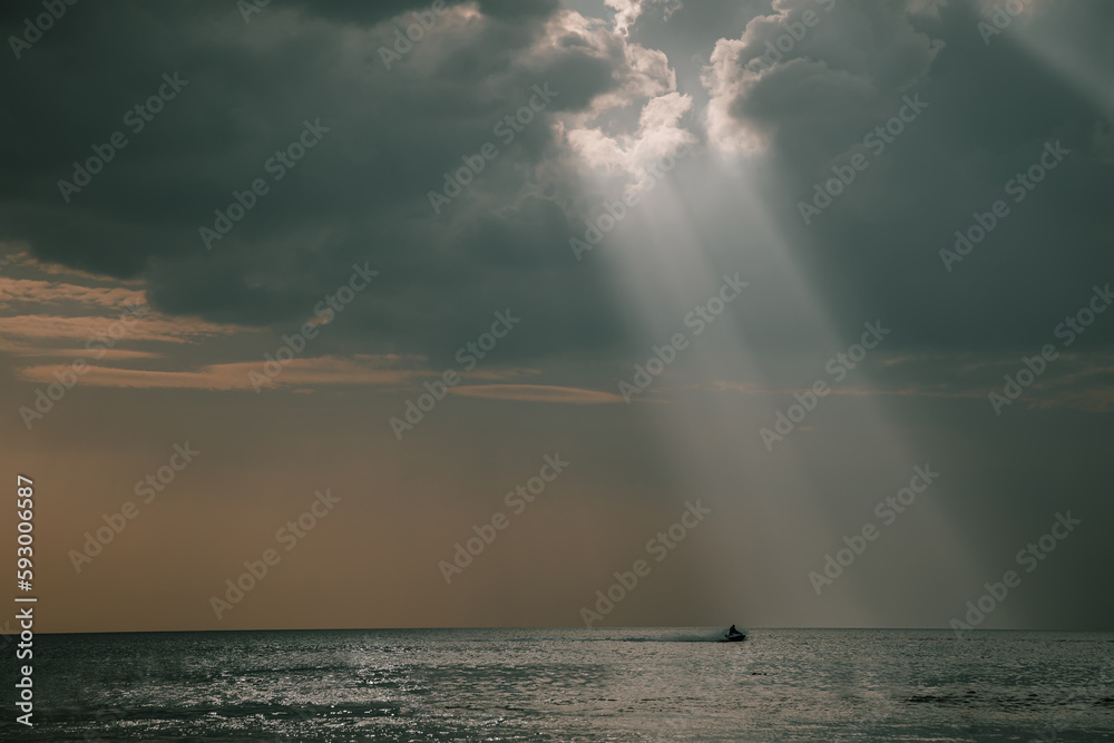 Beautiful rays of light fall into the sea. Cloudy sky. Beautiful light. Sea water. Evening light. Beautiful rays of light fall into the sea. Cloudy sky. Beautiful light. Sea water. Evening light.