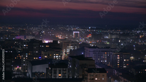 Beautiful night city of Bishkek with buildings and cars and fireworks