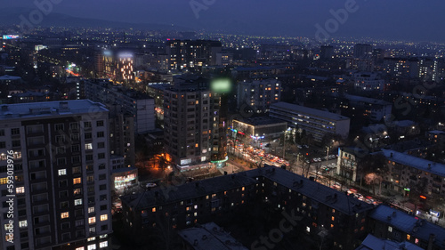 Beautiful night city of Bishkek with buildings and cars and fireworks © Aksmedia