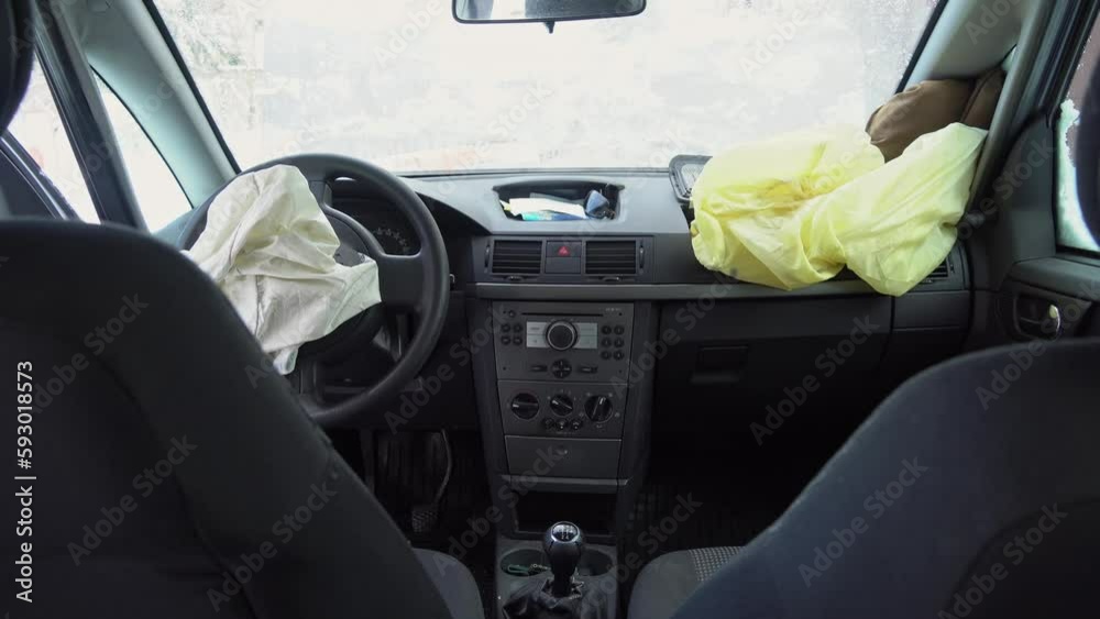 Deployed car airbags after a collision, car accident, vehicle security system after car crash. Deflated air bag Deployed car airbags after a collision, car accident, vehicle security system after car crash. Deflated air bag