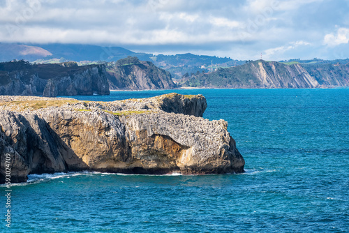 High rock cliffs jutting into the Cantabrian Sea off the coast of Asturias, Spain. photo