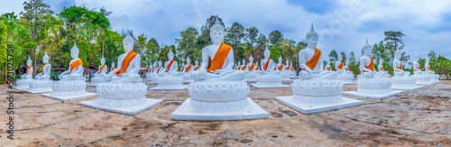 White buddha statues outdoor in Khemmarat, Ubon Ratchathani province, Thailand. photo