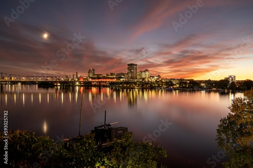Long exposure shot of Gatineau under a colorful sunset sky with the moon