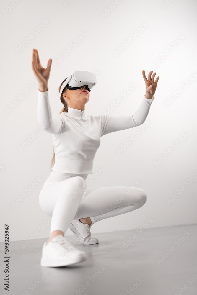 Futuristic looking woman with VR headset exploring virtual reality metaverse world Futuristic looking woman with VR headset exploring virtual reality metaverse world