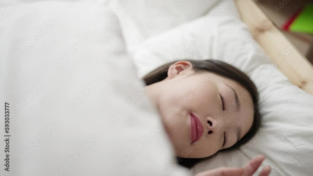 Young chinese woman lying on bed sleeping at bedroom Young chinese woman lying on bed sleeping at bedroom