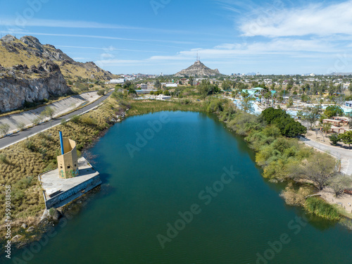 Small lake inside the city with a hill in the background