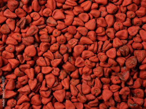 Annatto seeds, achiote seeds, bixa orellana background. Natural dye for cooking and food. Close-up food background. photo