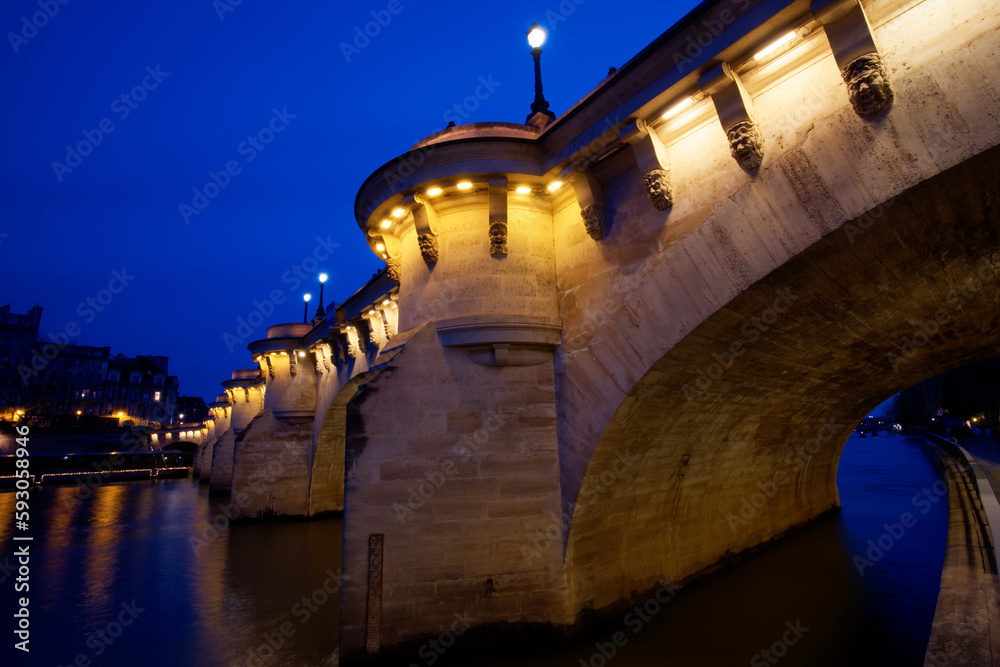 CItyscape of downtown with Pont Neuf Bridge and River Seine at night , Paris.