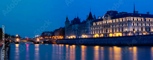 Beautiful view of Seine and Conciergerie at night in Paris.