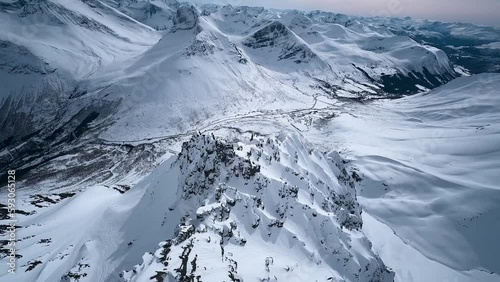 Drone flying thru Norwegian snowy mountains and alps