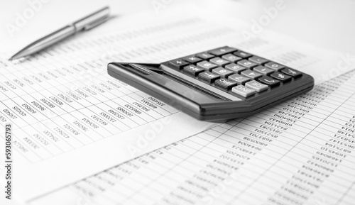 Calculator on financial statement and balance sheeet on desk of auditor. Concept of accounting and audit business.