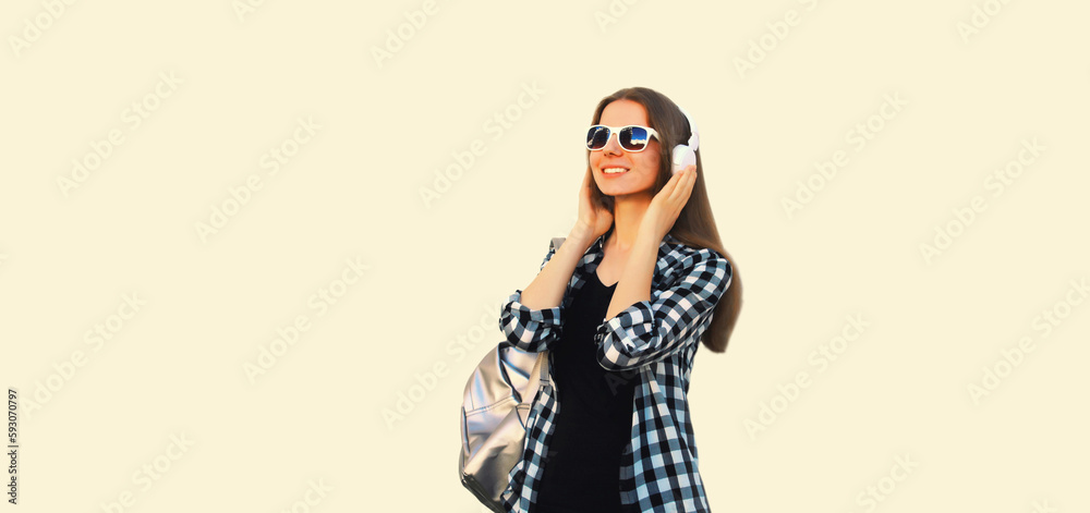 Portrait of happy smiling young woman in wireless headphones listening to music on white background Portrait of happy smiling young woman in wireless headphones listening to music on white background