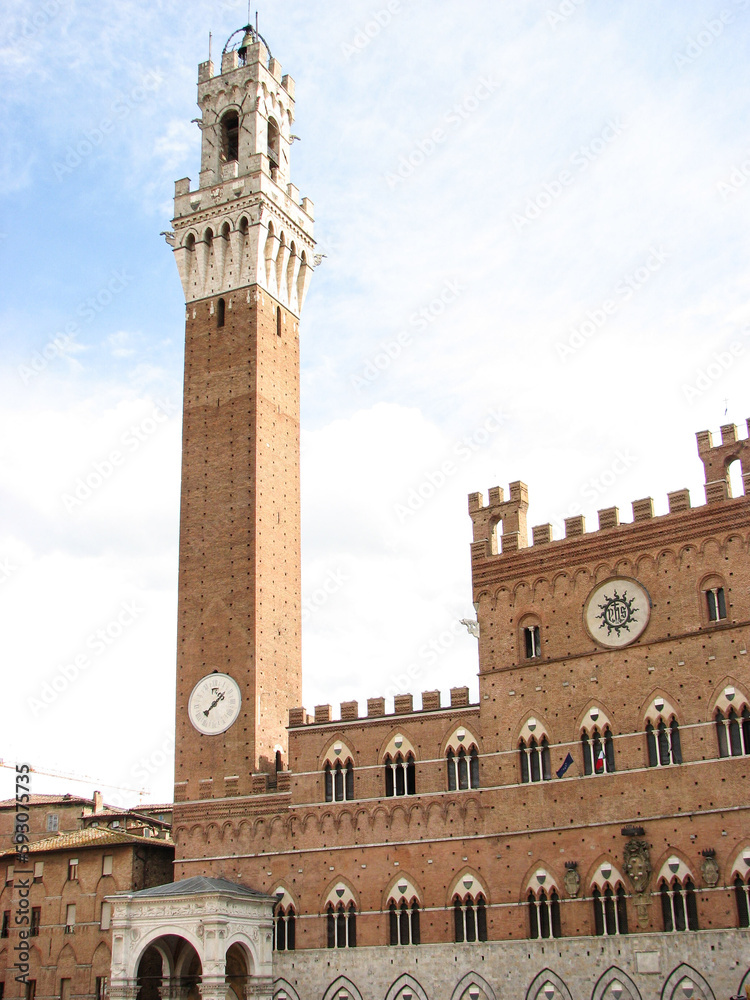 Siena, Italy - October 4 2006 - Torre del Mangia, a tall tower on Piazza del Campo, the main square in the Tuscan city of Siena, Italy.  Image has copy space.