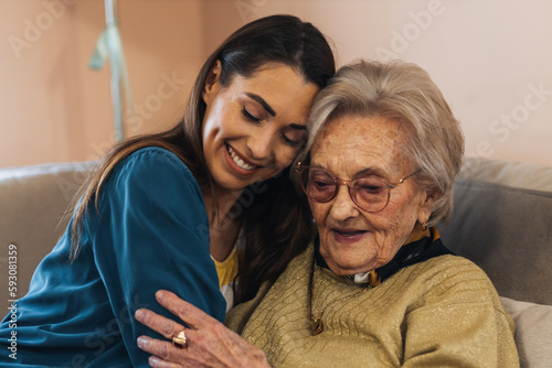 Granddaughter and grandmother hugging.